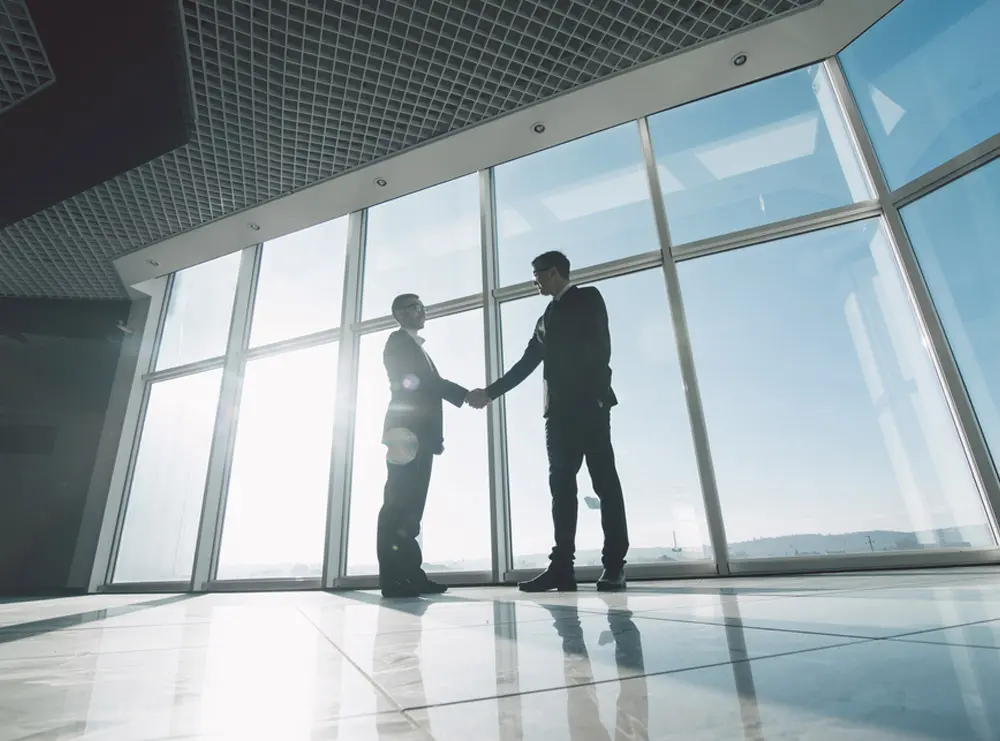 Small business owner shaking hands with investor